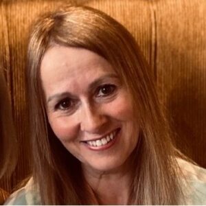 headshot of caren who is smiling at the camera.